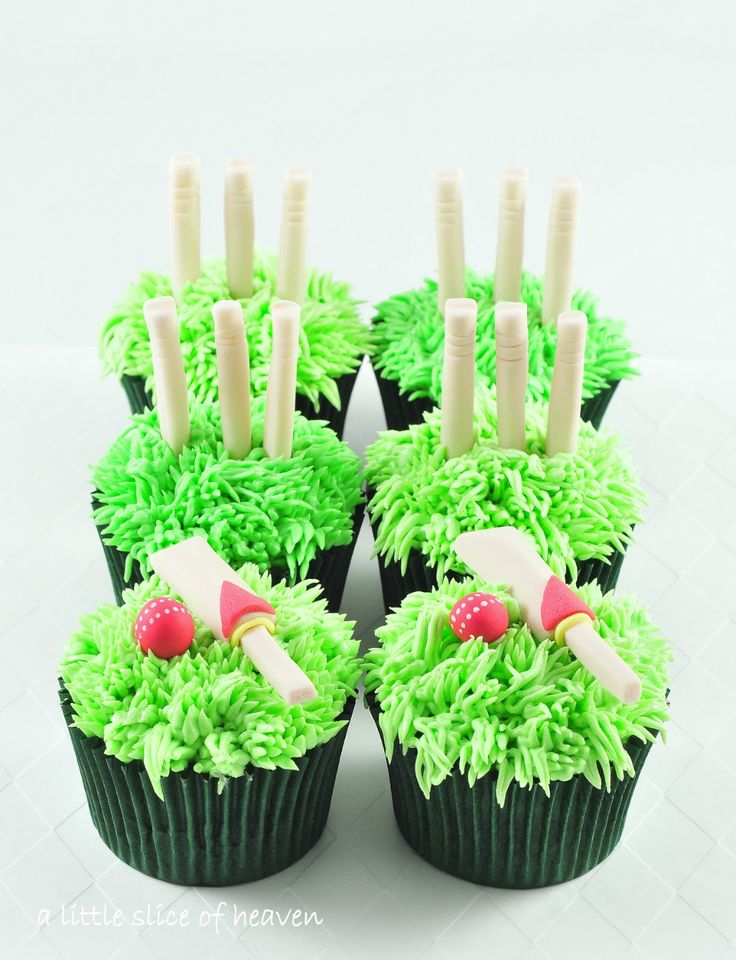 cupcakes with green frosting and decorations on them