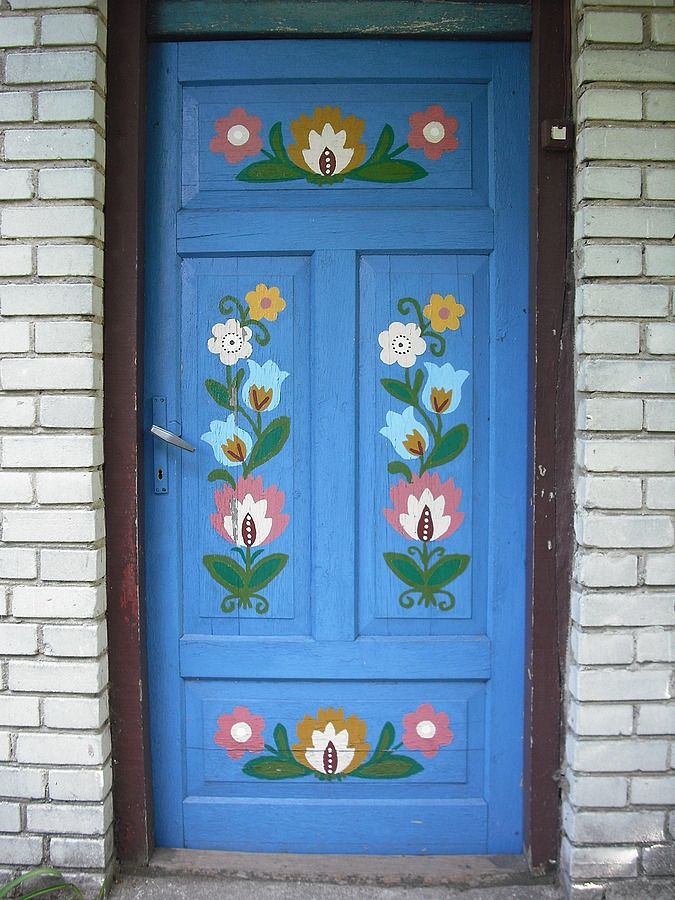 a blue door with flowers painted on it