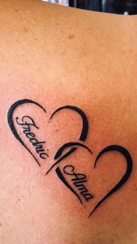 a couple of hearts with the names of two people on their backs and one is in the shape of a heart