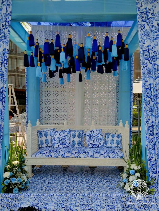 a blue and white bed sitting under a canopy