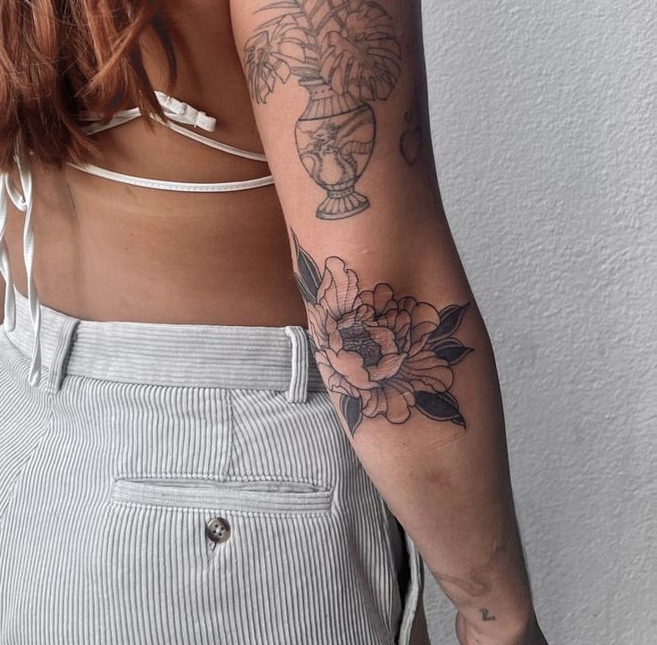 a woman's arm with flowers on it