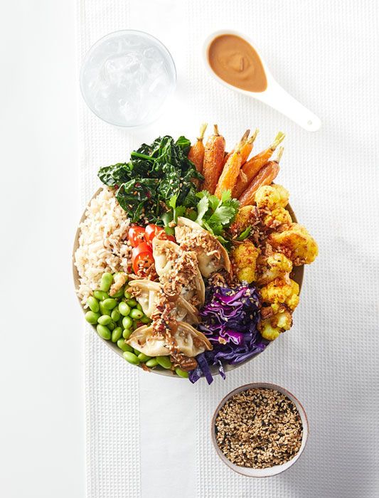 an overhead view of a plate of food with rice, carrots, peas and broccoli