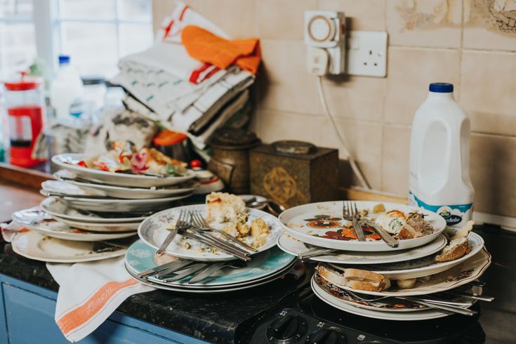 several plates are stacked on top of each other in the middle of a kitchen counter