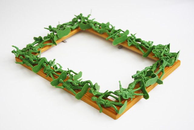 a wooden frame with green leaves on it