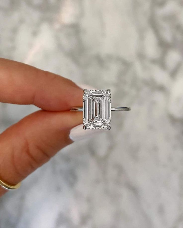 "Specification:- Stone Details :-  *Diamond Material: Cubic Zirconia (CZ)  & Moissanite ( As Per Order ) *Diamond Shape : Emerald Cut *       Total Diamond Weight : 8.8 CT (Approx.) *       Diamond Dimension : 15*10  MM  *Diamond Color: Near White  *Clarity: VVS *Certificate : AGL/ AGS (ONLINE) *Making Process: Handmade by our Experienced Staff. *Stamp: Our All Rings Stamped According to metal Purity (925 SIL/10K/14K/18K). Custom Order:- *We do Accept Custom order. *Buyer can also request customization in listed Items (Charges apply according to required Customization). Customization:- *Buyer can Request change of rhodium color in 925 Silver Jewelry (No additional Charge). *In Gold (10K, 14K, 18K) buyer can change gold color (White, Rose, Yellow). *Buyer can also change CZ Stone Color (No Ring For Girlfriend, Minimalist Wedding Rings, Solitaire Wedding Ring, Gold Promise Ring, Emerald Cut Diamond Engagement Ring, Jewelry Certificate, Emerald Cut Diamond Engagement, Ring Proposal, Emerald Cut Diamond Ring