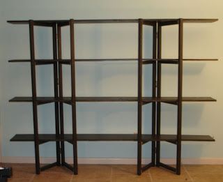 an empty book shelf in the corner of a room