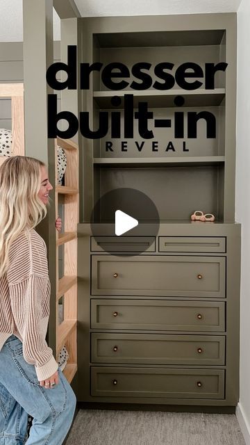 a woman is sitting on the floor in front of a dresser with drawers and shelves