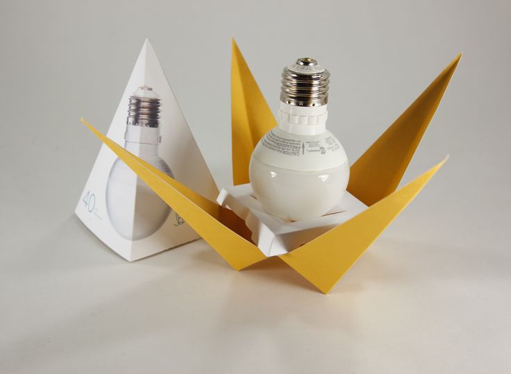 an origami light bulb in a box with its lid open to show it's contents