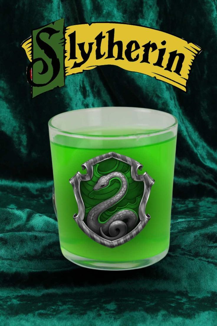 a green candle with the slytherin logo on it and a banner above it