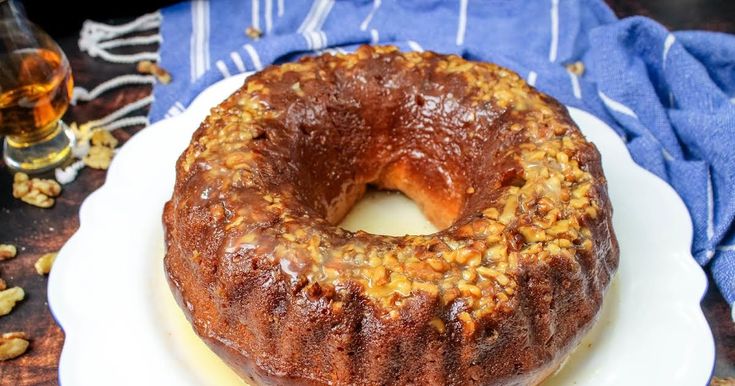 a bundt cake sitting on top of a white plate next to a blue napkin