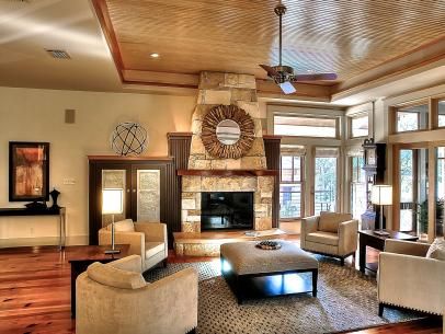 a living room filled with furniture and a fire place in the middle of a room