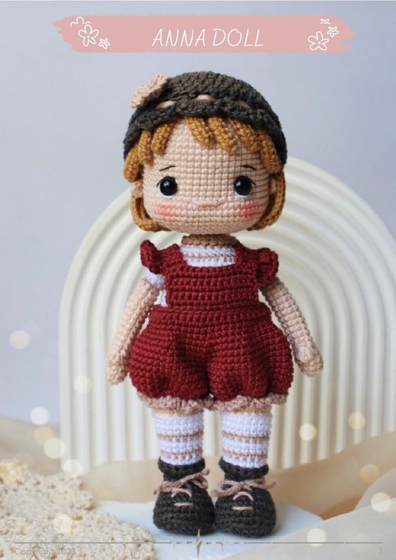 a crocheted doll is standing in front of a white background