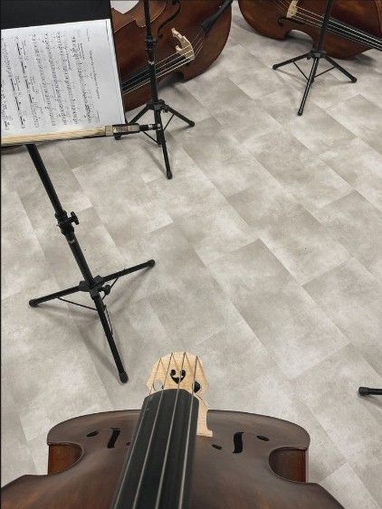 an instrument and music stand with sheet music on the floor next to eachother