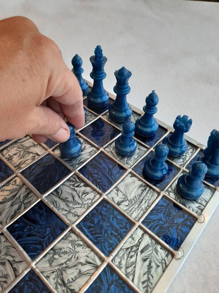 a person playing chess with blue and white tiles