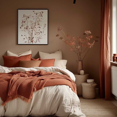 a bed sitting in a bedroom next to a window covered in orange and white blankets