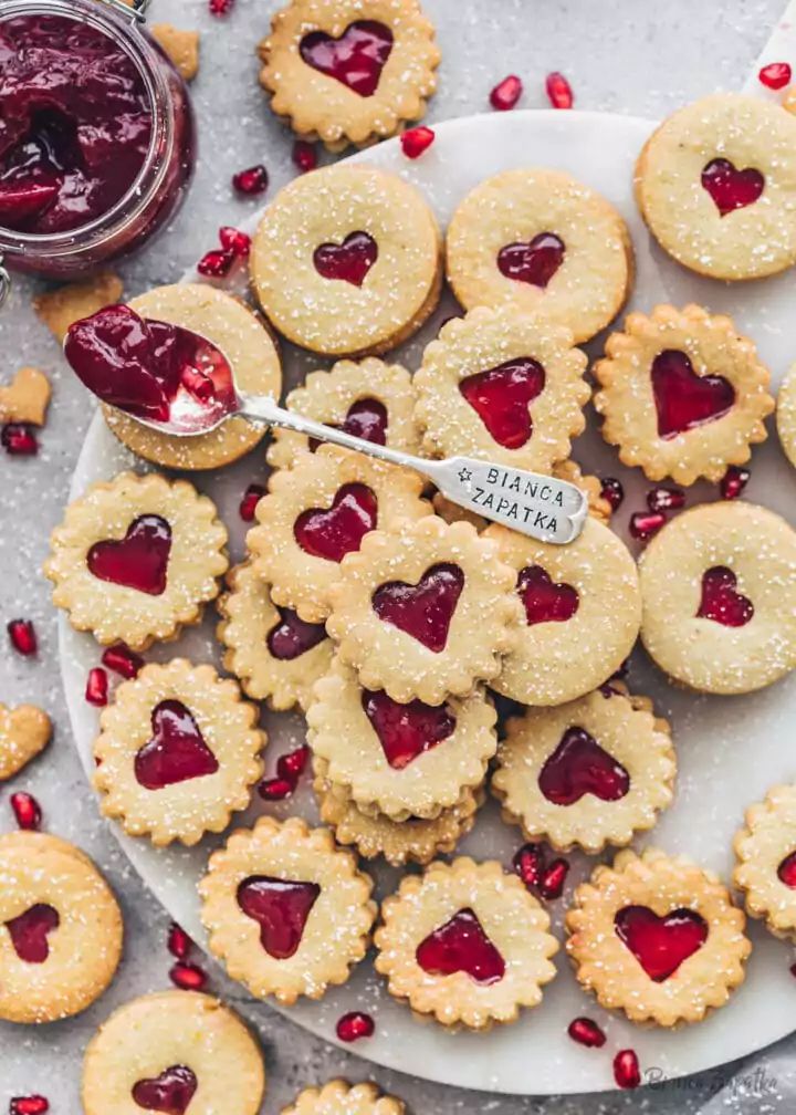 small heart shaped cookies on a plate with jam