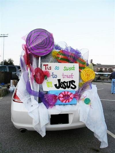 a car decorated with yarn and flowers in a parking lot