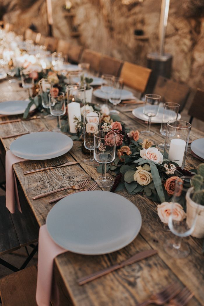 the table is set with plates and place settings for an elegant dinner or wedding reception