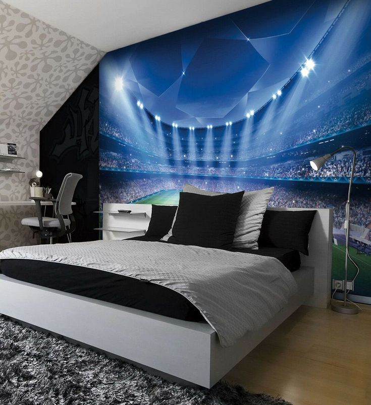 a bedroom with a large stadium wall mural