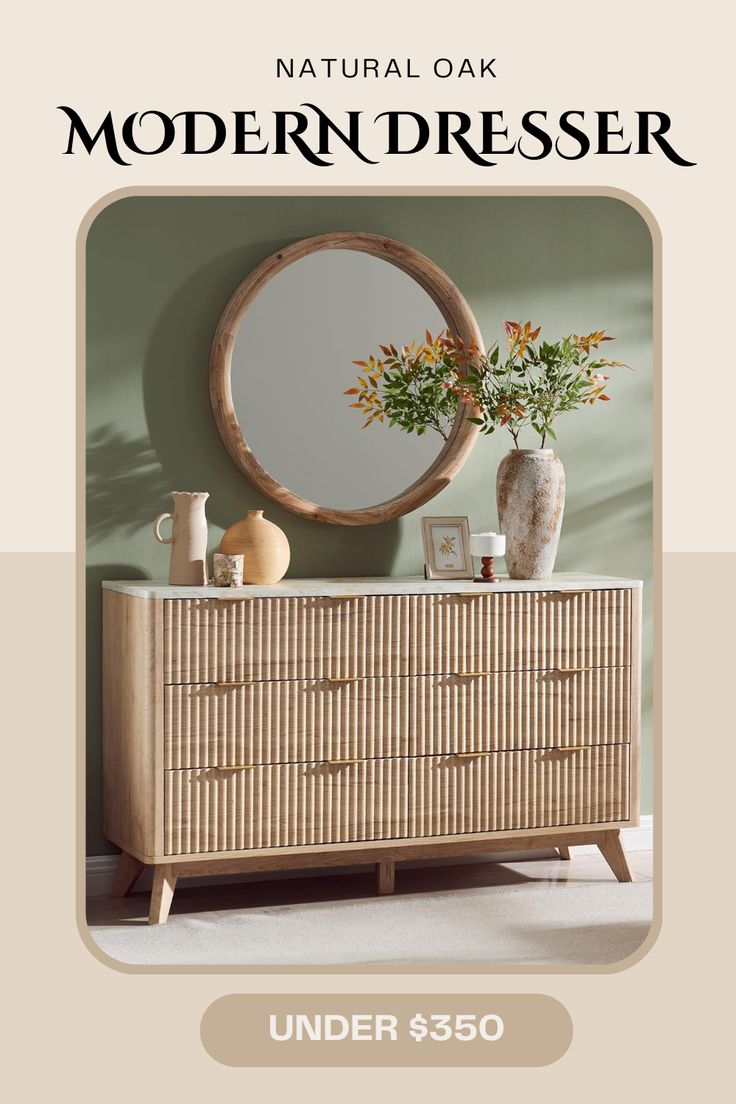 a wooden dresser sitting next to a mirror and vase on top of it in front of a green wall