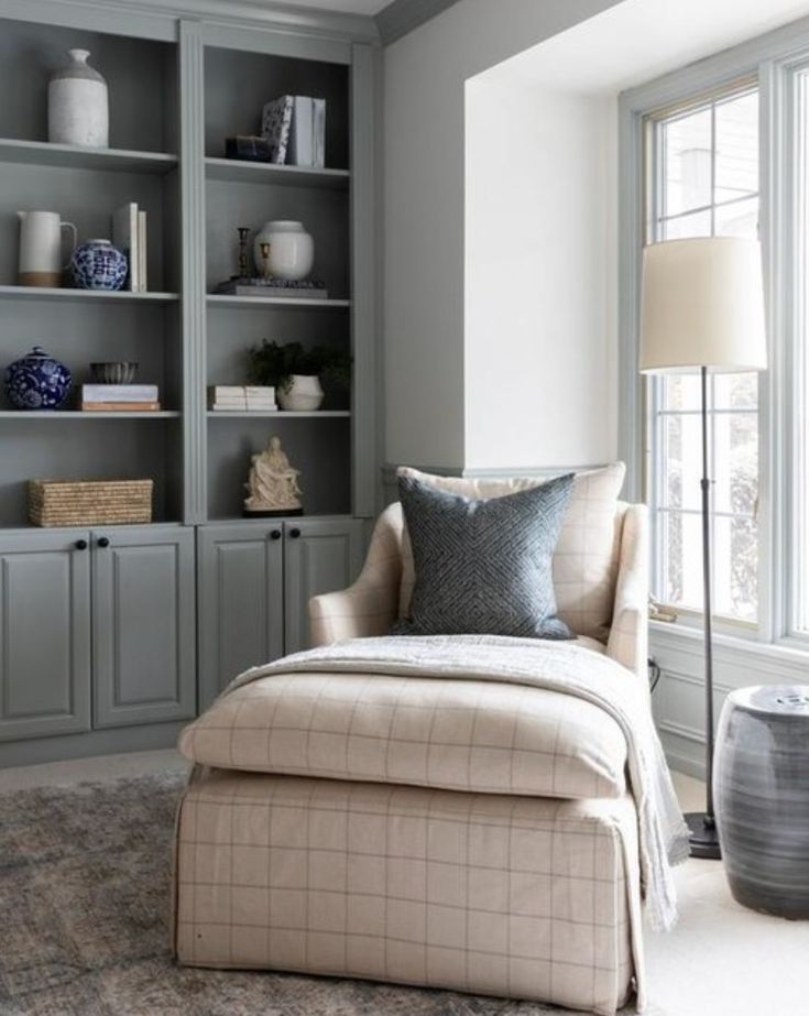 a living room filled with furniture and bookshelves on top of eachother