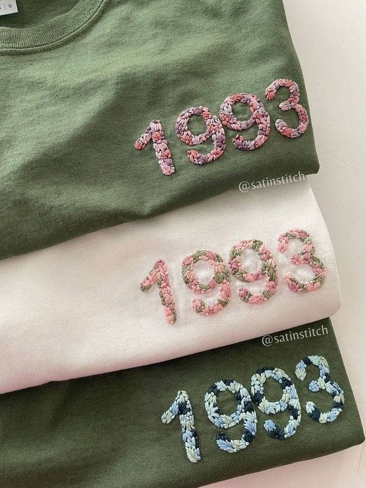 three t - shirts with numbers on them sitting next to each other