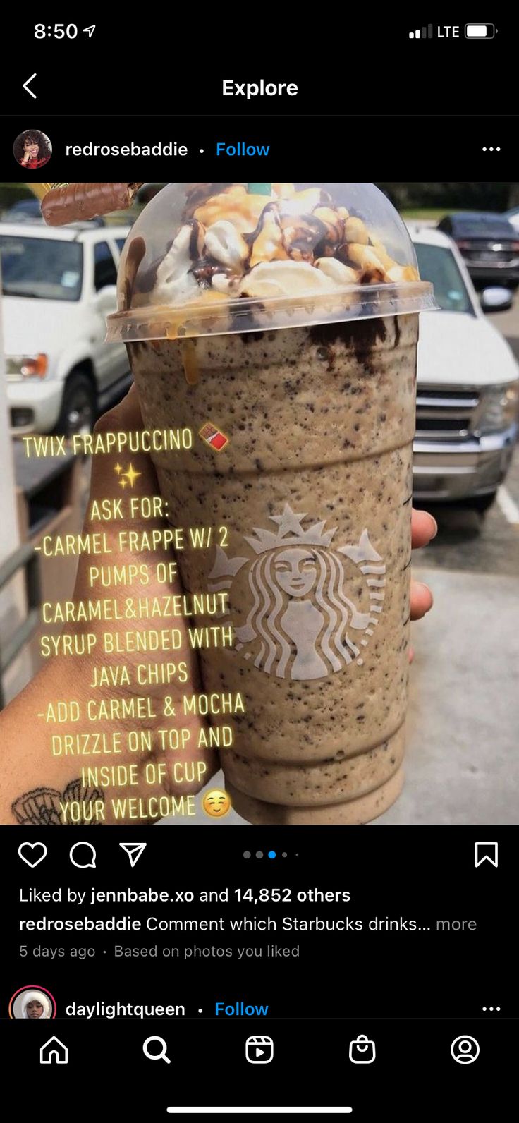 someone is holding up a cup of coffee with the words starbucks on it and there are cars in the background