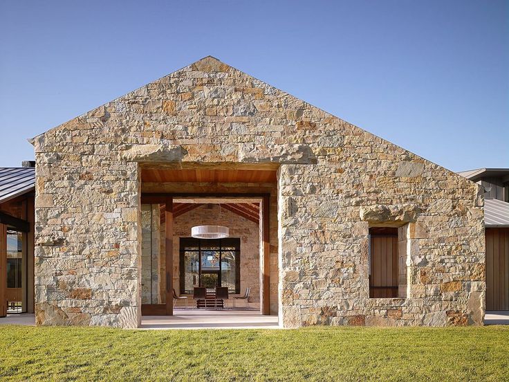 a stone building with an open front door