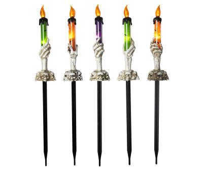 four different colored candles in the shape of hands