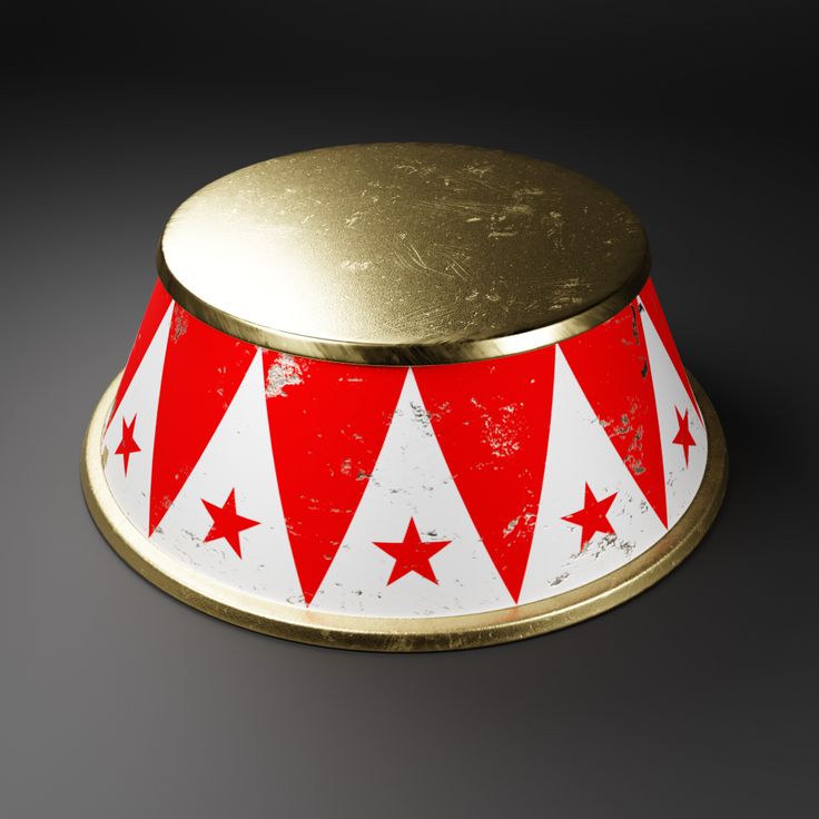 a red and white metal bowl with stars on the bottom, sitting on a black surface