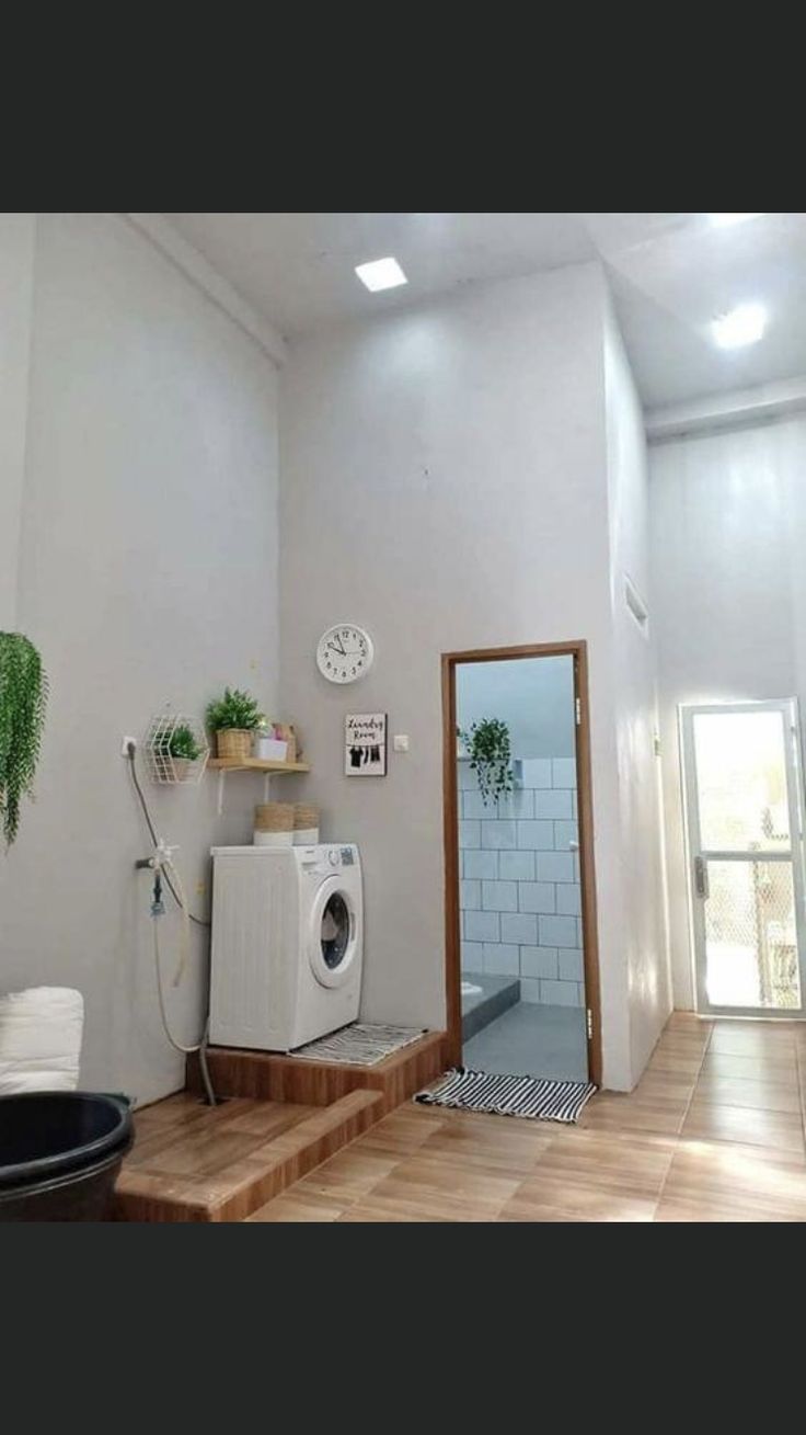 a washer and dryer sitting on top of a wooden step in a room