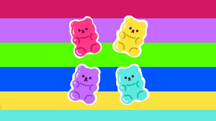 three gummy bears sitting on top of each other in front of a rainbow colored background