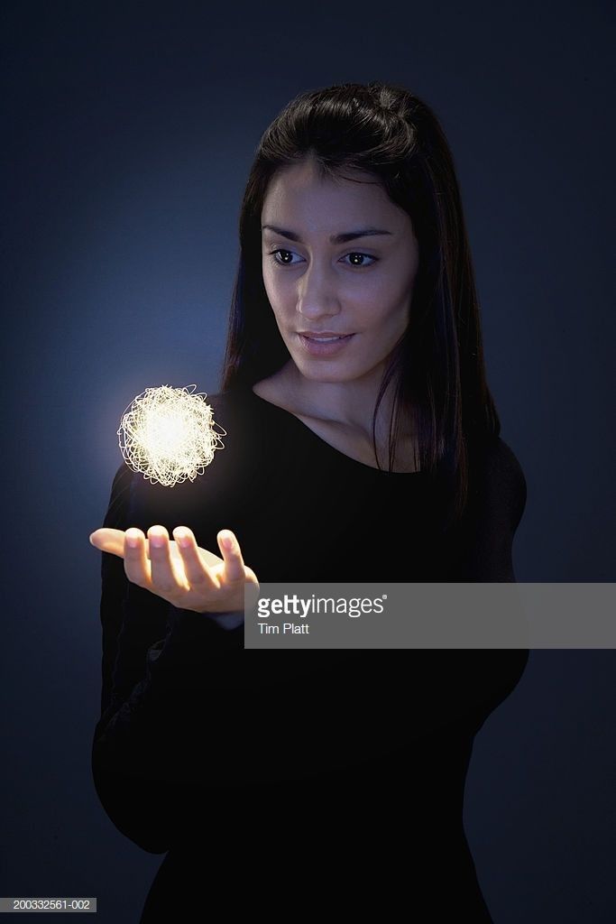 a young woman holding a dandelion ball in her hand stock - fotop