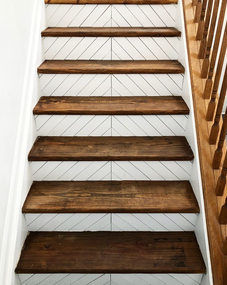 wooden stairs with white painted walls and wood handrails