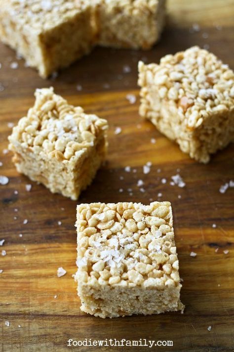 four pieces of rice krispy treats sitting on top of a wooden table