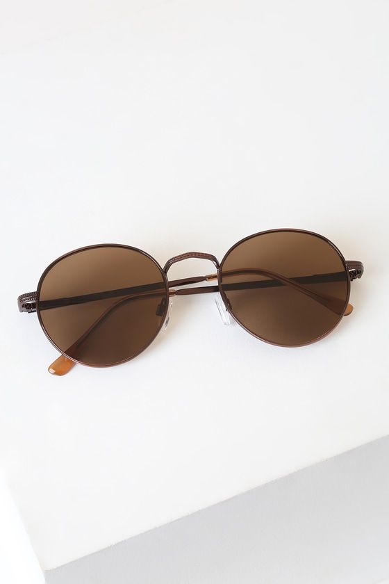 Sunny days don't stand a chance with the Lulus Agreed Bronze Round Sunglasses! These trendy bronze round sunnies feature a sleek wire-frame with brown tinted lenses. Engraved detail along nose bridge and arms. Get ready for these shades to be your favorite go-to pair! Frames measure 5. 5" wide. Arms measure 5. 5" long. Nickel, brass and plastic. Imported. Lulus | Agreed Bronze Round Sunglasses. Casual Brown Sunglasses With Metal Frame, Brown Round Sunglasses For Summer, Brown Round Sunglasses For Beach, Brown Round Frame Sunglasses With Metal Frame, Brown Round Frame Metal Sunglasses, Classic Brown Sunglasses For Spring, Brown Aviator Sunglasses With Uv Protection For Spring, Brown Aviator Sunglasses With Uv Protection, Spring Break Packing List