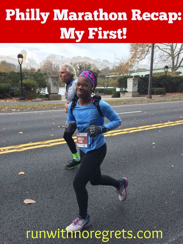 a woman running in a marathon with the words phily marathon recap my first