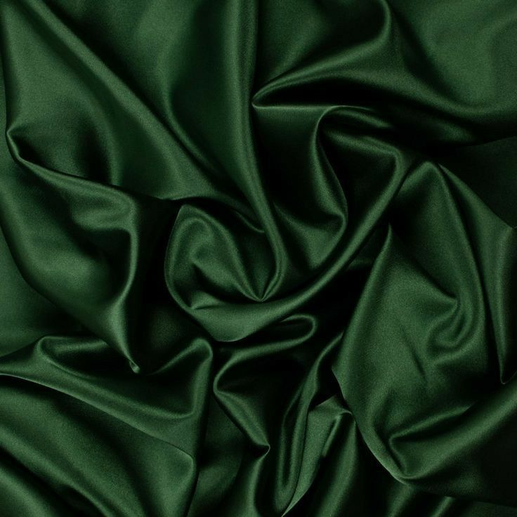 a close up view of a green satin fabric with very high resolution and soft folds