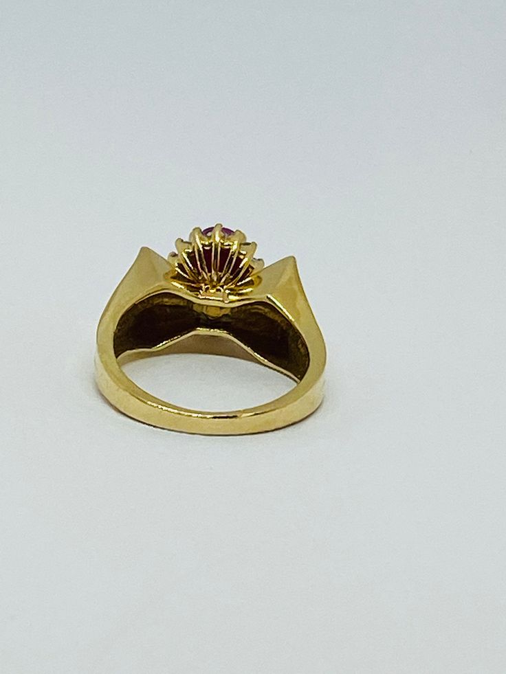 "This is a vintage 14K yellow gold, ruby, and diamond statement ring. The sharp edges of this ring give it a polished and refined look. Material(s): 14K yellow gold + (1) oval ruby + several diamonds Weight: 5.3 grams Flaws (if any): None to mention Marking(s): \"14K\" BAND SIZE 4 3/4 (or 4.75)" Heirloom Gold Ruby Ring With Diamonds, Classic Gold Ruby Ring Brilliant Cut, Classic Gold Ruby Ring With Brilliant Cut, Formal 14k Gold Ruby Ring With Single Cut Diamonds, Classic Yellow Gold Ruby Ring With Single Cut Diamonds, Vintage Yellow Gold Dome Ring With Polished Finish, Antique Gold Ruby Ring With Diamonds, Formal Gold Ruby Ring With Single Cut Diamonds, Formal Yellow Gold Ruby Ring With Single Cut Diamonds