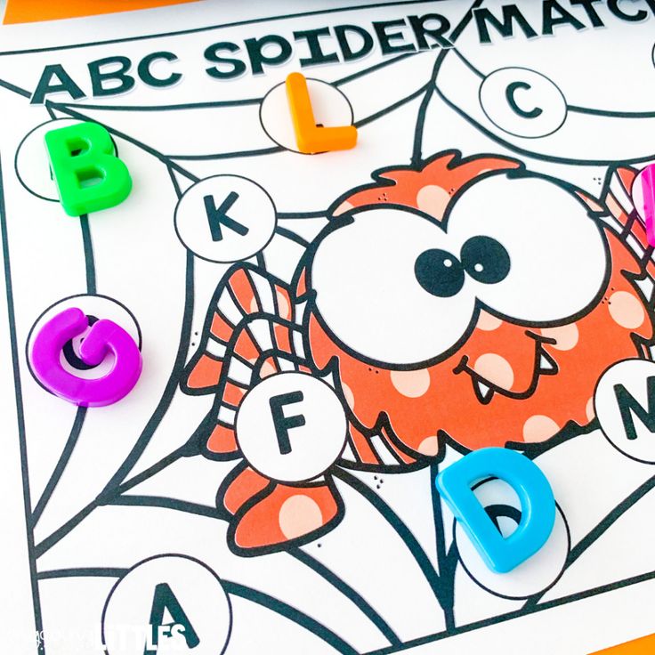 a close up of an abc and d spider match game with magnets on it