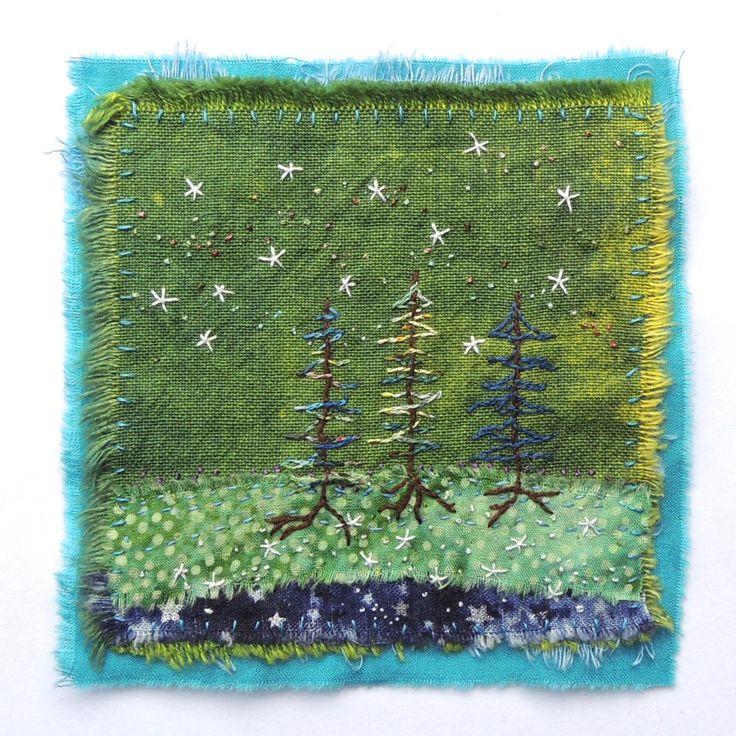 a piece of fabric with trees and stars on it