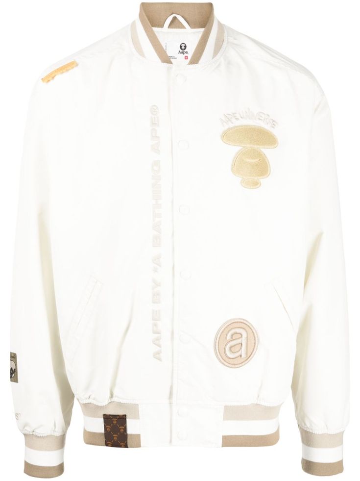 white/beige embroidered logo at the chest all-over motif embroidery baseball collar stripe detailing front press-stud fastening two front welt pockets ribbed cuffs and hem long sleeves White Varsity Jacket With Patches For Streetwear, White Varsity Jacket With Embroidered Logo For Streetwear, Embroidered Cotton Varsity Jacket For Streetwear, White Varsity Outerwear With Embroidered Graphics, Luxury Embroidered Varsity Outerwear, Motif Embroidery, Embroidery Baseball, Bathing Ape, A Bathing Ape