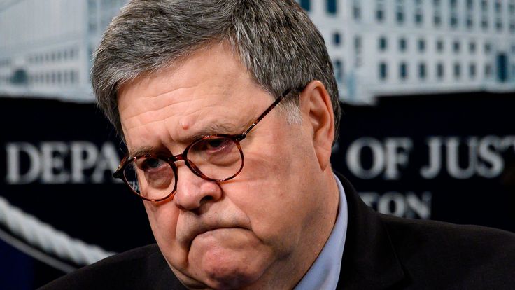 a close up of a person wearing glasses and a suit with a tie in front of a white house