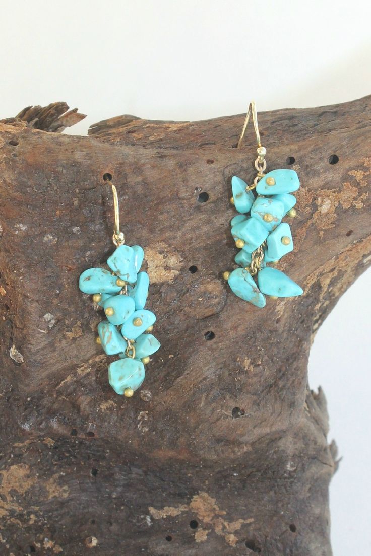 Turquoise stone chips form a full cluster of natural beauty! These hook earrings are set in bright gold with a 1.5" drop. Cheap Natural Earrings As Gift, Cheap Natural Stones Earrings, Stone Chips Jewelry, Chip Beads Earrings, Turquoise Chip Jewelry, Turquoise Beaded Earrings With Natural Stones, Diy Stone Chip Earrings, Chip Jewelry Gemstone, Stone Chip Earrings