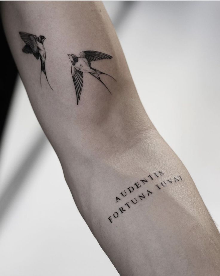 a couple of birds that are on top of a arm with the words underneath it