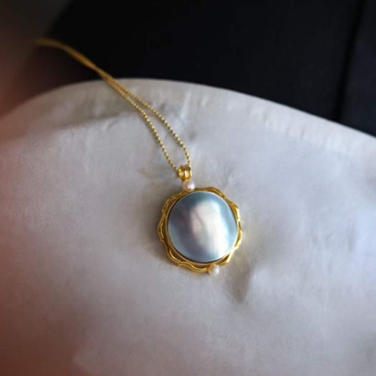 Natural mabe pearl blue color pendant Gold Vermeil Material: Gold Vermeil on 925 Sterling Silver, Natural Sea Mabe Pearl Note: Our jewelry is handmade. Naturally formed shapes of freshwater baroque pearls and gemstones may vary. The actual product may be slightly different from the pictures shown. Elegant Baroque Pearl Necklace As Gift, Elegant Baroque Pearl Necklace Gift, Elegant Baroque Pearl Necklace With Gemstone, Blue Pearl Pendant Fine Jewelry, Fine Blue Pearl Pendant Jewelry, Fine Jewelry Pearl Necklace With Pendant For Jewelry Making, Fine Jewelry Pearl Necklace For Jewelry Making, Luxury Baroque Pearl Jewelry For Gifts, Luxury Baroque Pearl Jewelry Gift