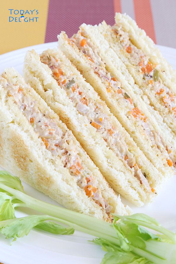 a close up of a sandwich on a plate with lettuce and carrots