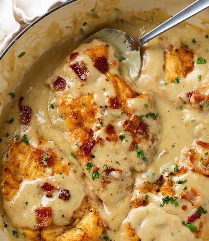 a skillet filled with chicken covered in gravy