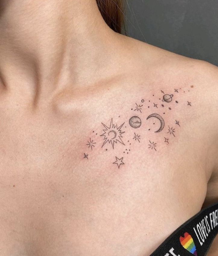 a woman's chest with stars and moon tattoos on her left side breast area