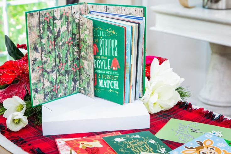 a table topped with lots of christmas cards and greeting cards on top of each other